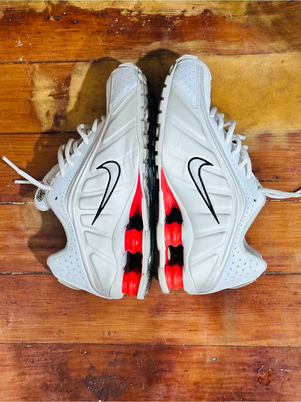 Nike White Sneakers with Black Swoosh and Red Midsole Accents